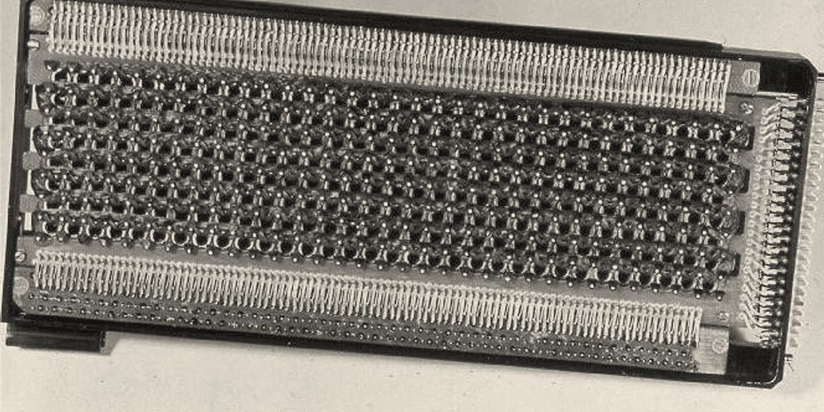 Close-up of Apollo Guidance Computer core rope memory: dense rows of tiny magnetic rings threaded with wire.