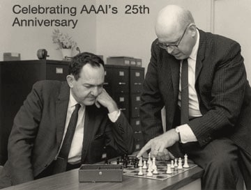 Herbert Simon seated with his chin on his hand and Allen Newell leaning in to move a piece, over a chessboard, 1958.